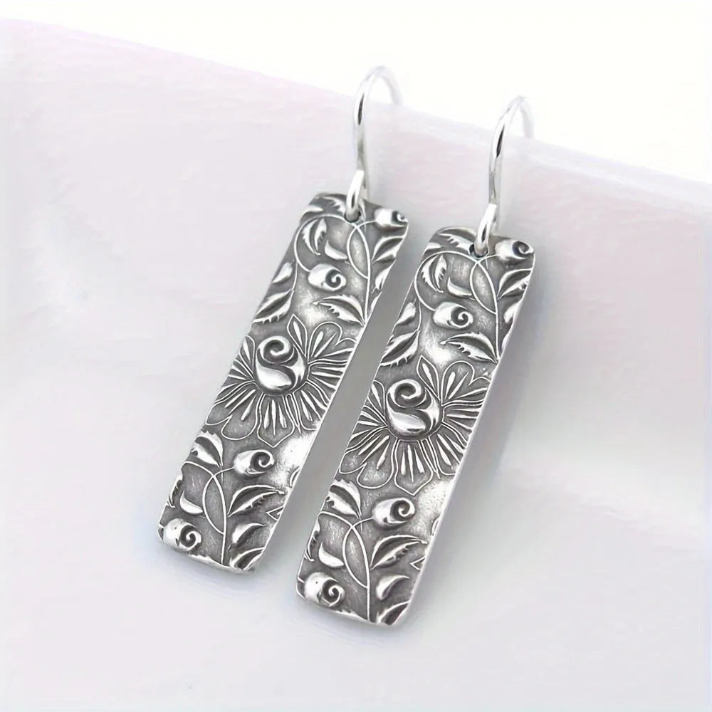 Silver long earrings with geometric shapes and carved vine detailing in zinc alloy construction