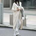 Long grey knitted women's cardigan with hood and trench coat design, shown open as a front-fastening garment.