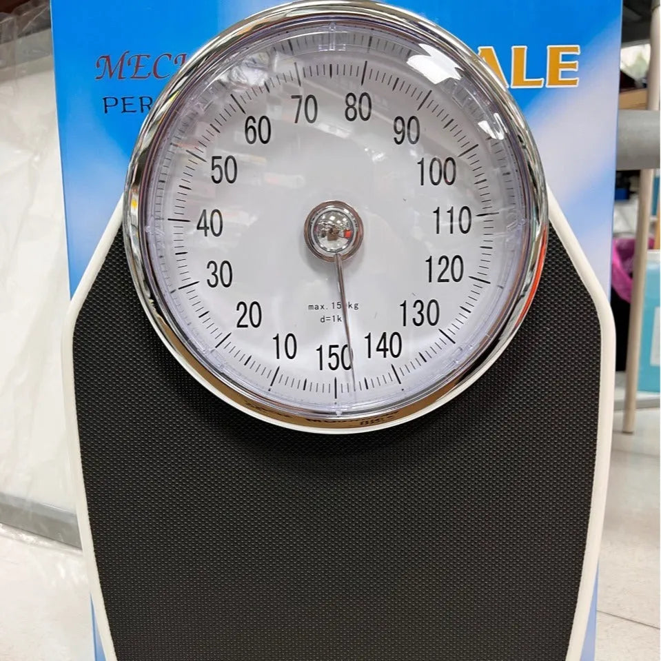 Black mechanical body weight scale with large dial and pointer on a simple platform