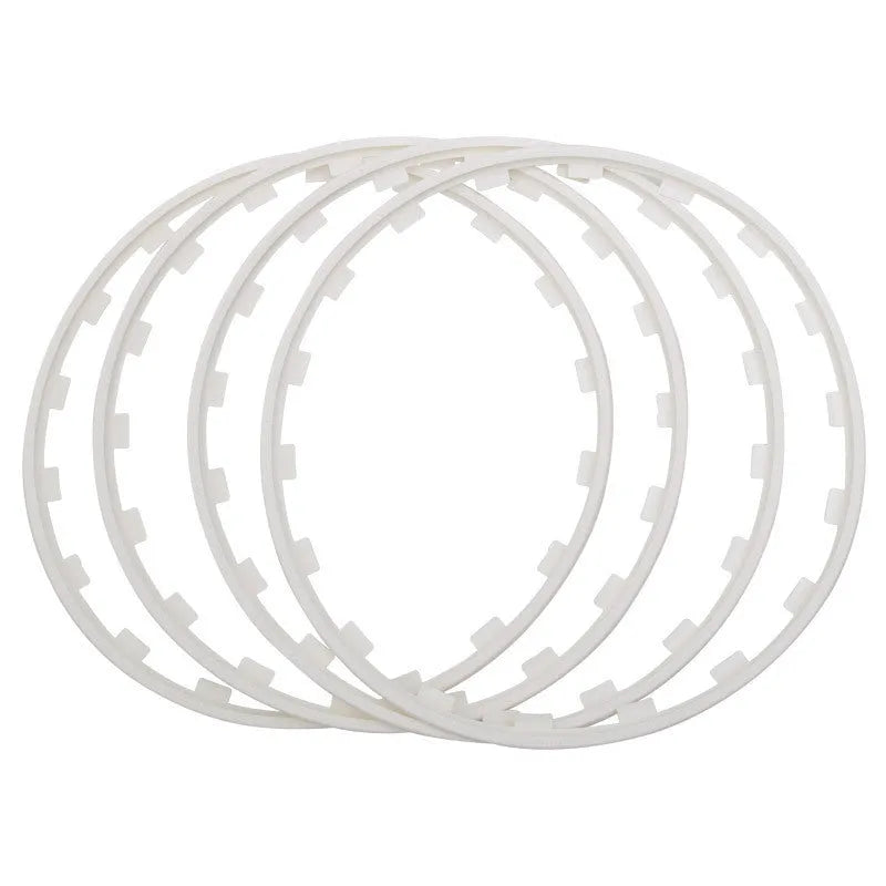 Set of four white nylon wheel hub protection rings for alloy wheels on a grey background.