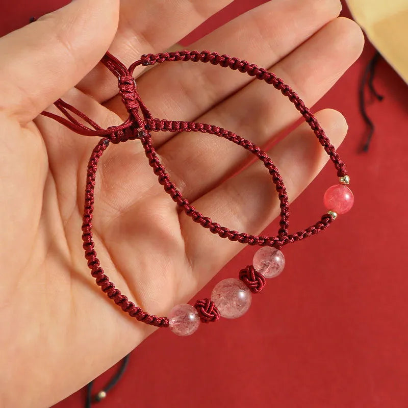 Red woven rope bracelet with spherical strawberry quartz beads and alloy accents