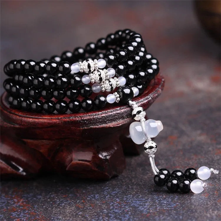 Natural red and black agate 108 bead prayer bracelet with geometric shapes.