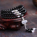 Natural red and black agate 108 bead prayer bracelet with geometric shapes.