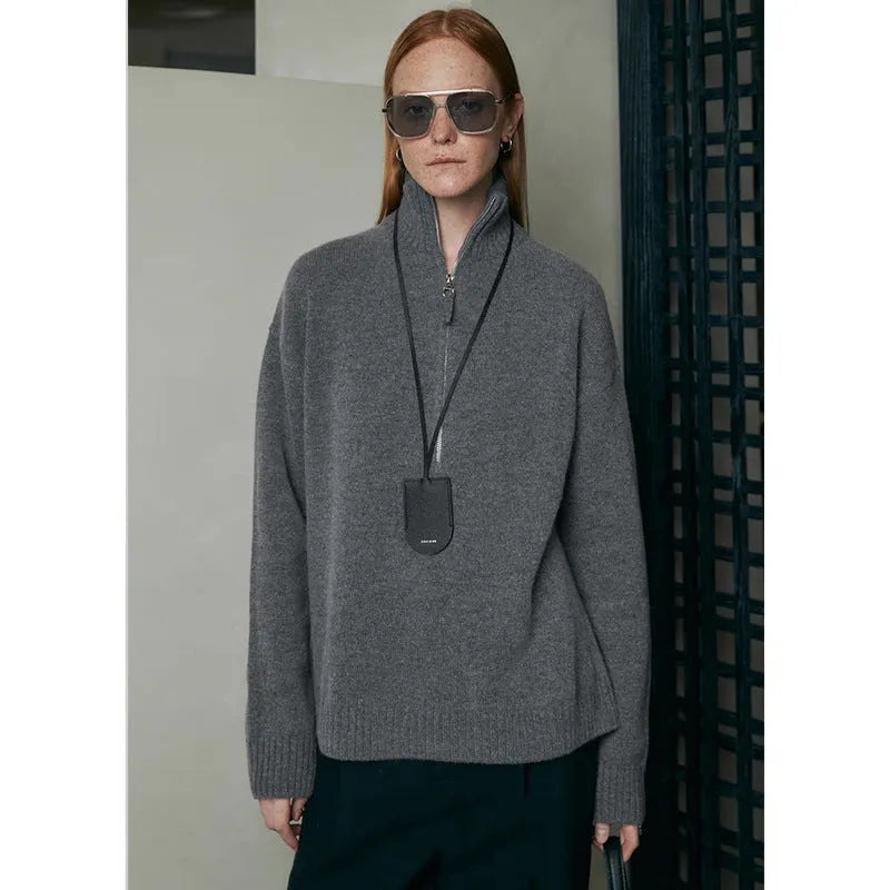 A woman's loose lapels bandage dress in wool, shown in black and grey, with long sleeves.