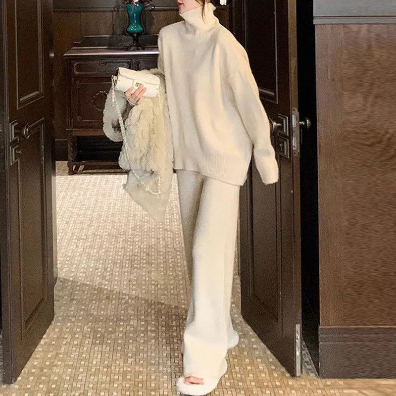 Women's milky white acrylic knit sweater and wide-leg trouser two-piece set on a hanger.