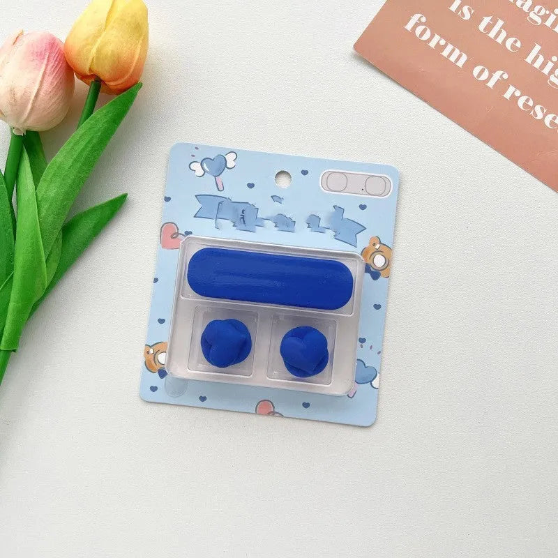 Plastic cartoon-style magnetic data cable fixer clip on a desktop