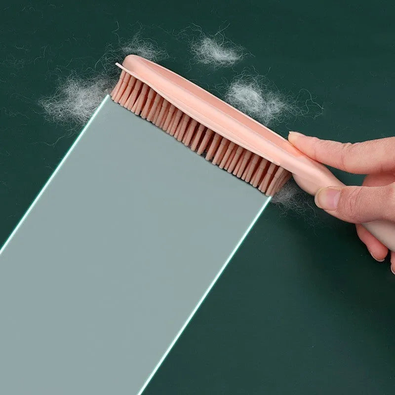 Green silicone pet hair remover brush with plastic handle on a fabric sofa