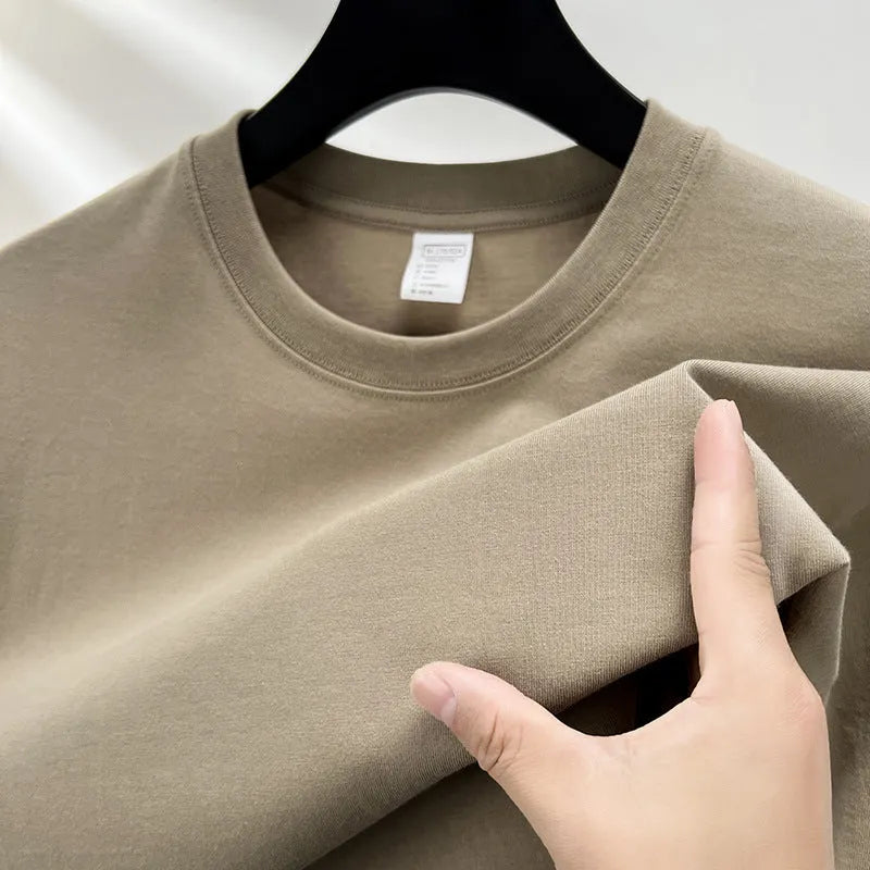 Men's solid colour cotton t-shirt with drop shoulder design on a hanger.