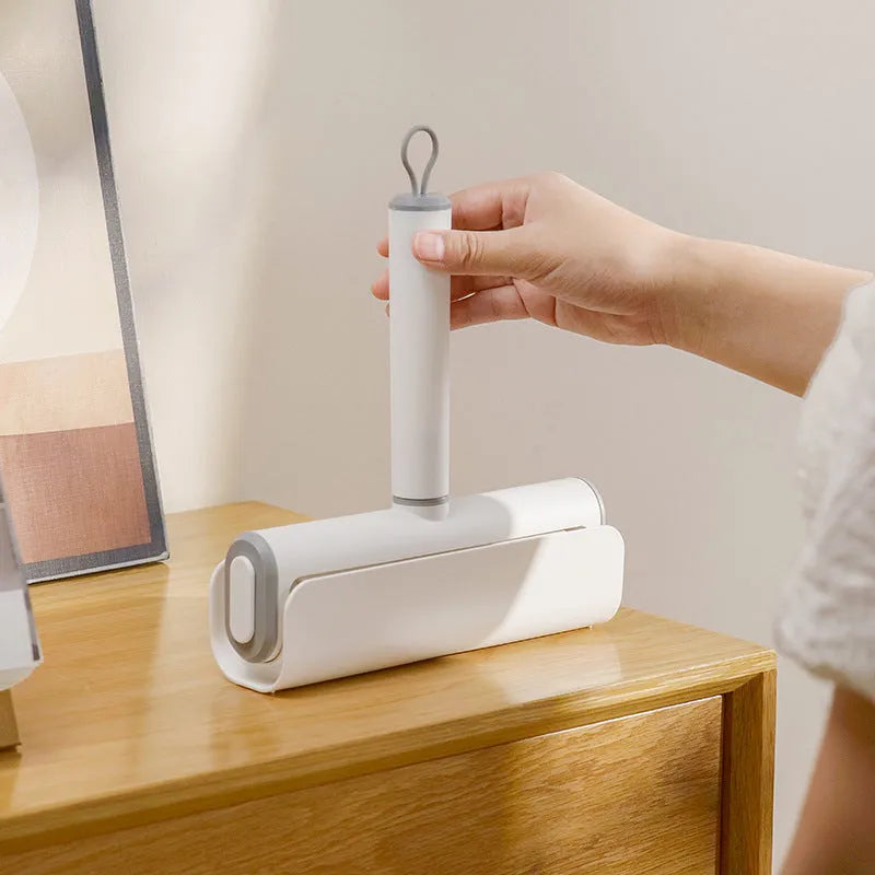 Handheld lint remover roller with tearable paper stick for removing pet hair from floors and furniture