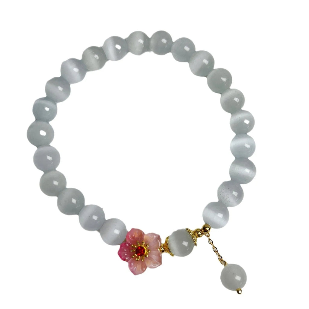 Close-up of a white opal flower beaded bracelet in Chinese style, made from glass and coloured glaze.