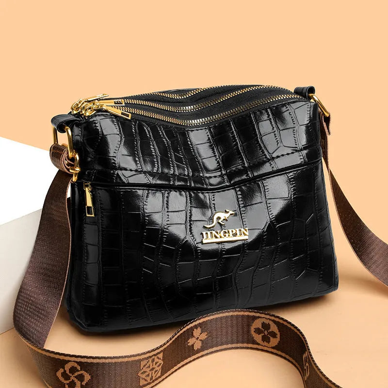 Brown cross body messenger bag with multiple compartments and sewing thread details on PU material