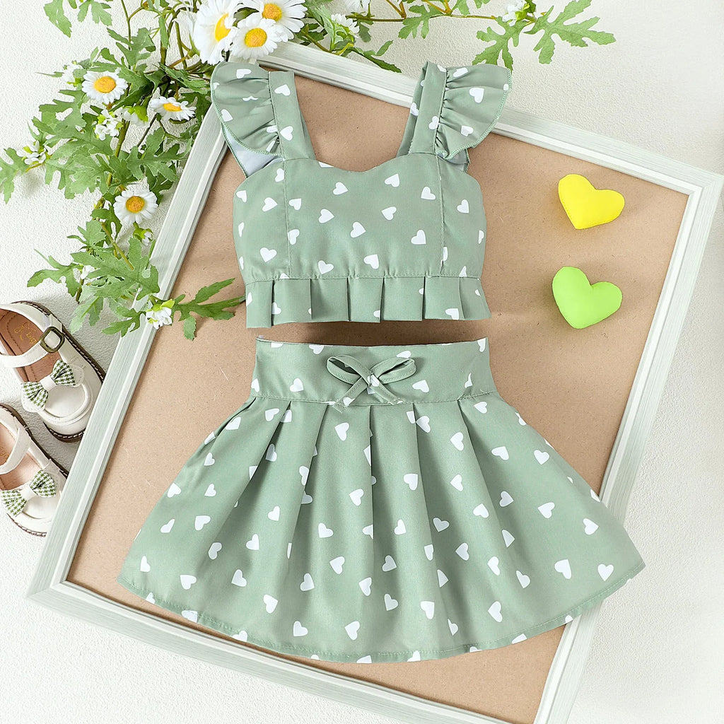 Girls' cotton two-piece skirt set with long-sleeve flounced top, bow, and pleated skirt in green or white