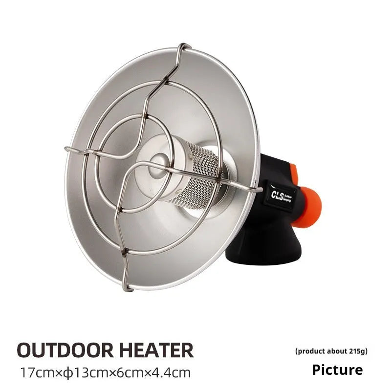 Black and orange portable camping heater stove with automatic ignition on a rocky outdoor surface.