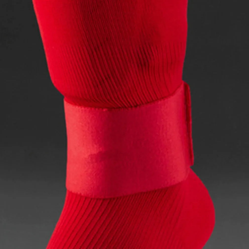 Red elastic rubber football shin guard tape belt laid flat, showing its length and width.