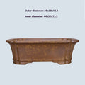 Hand-thrown rectangular purple sand flower pot with dual drainage holes on a wooden deck.