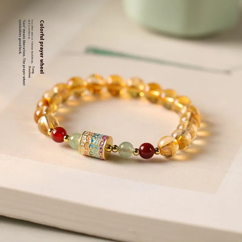 Yellow citrine bracelet with colourful prayer wheel beads on an 8mm round bead strand.