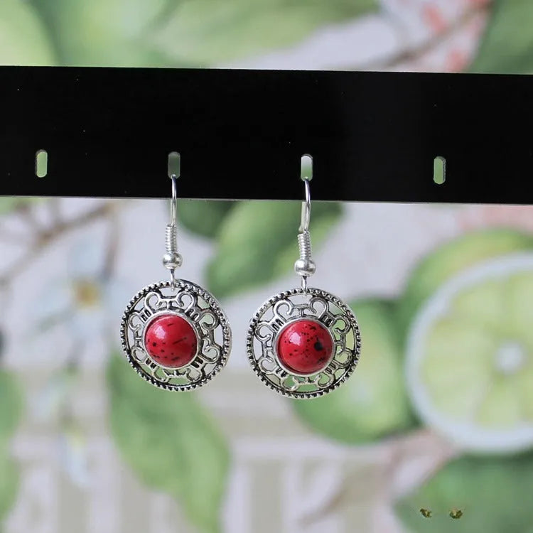 Handmade geometric ethnic earrings in Tibetan silver and turquoise with totem patterns.