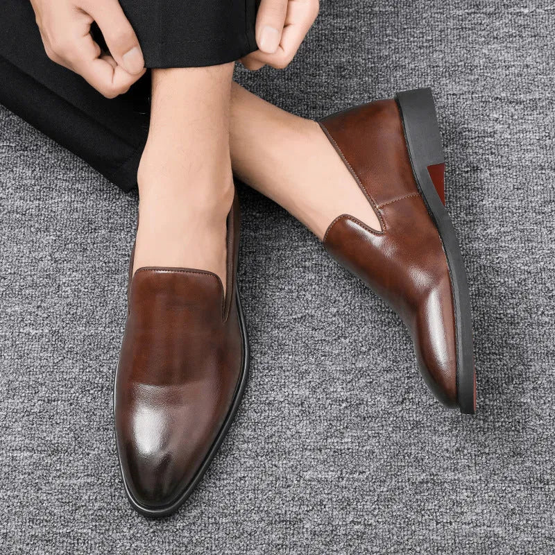 Men's polished pointed black leather shoes with leather toe cap and rubber sole, side view