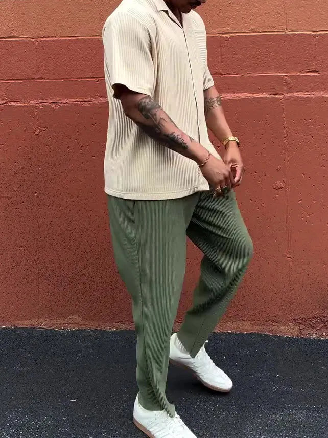 Men's green pleated casual trousers in polyester fabric showing ankle-length design and regular fit