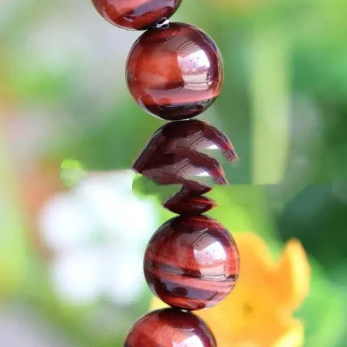 Tiger's eye stone bracelet with lightning cat's eye pattern in a round geometric ethnic style.