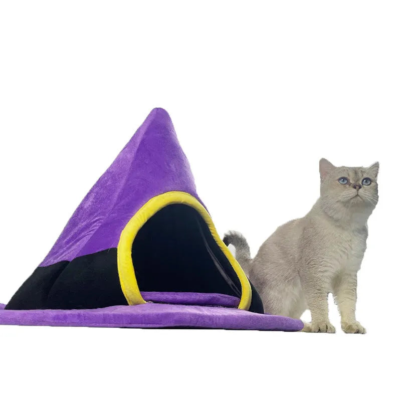 Purple witch hat-shaped cat bed for small pets, shown on a floor.