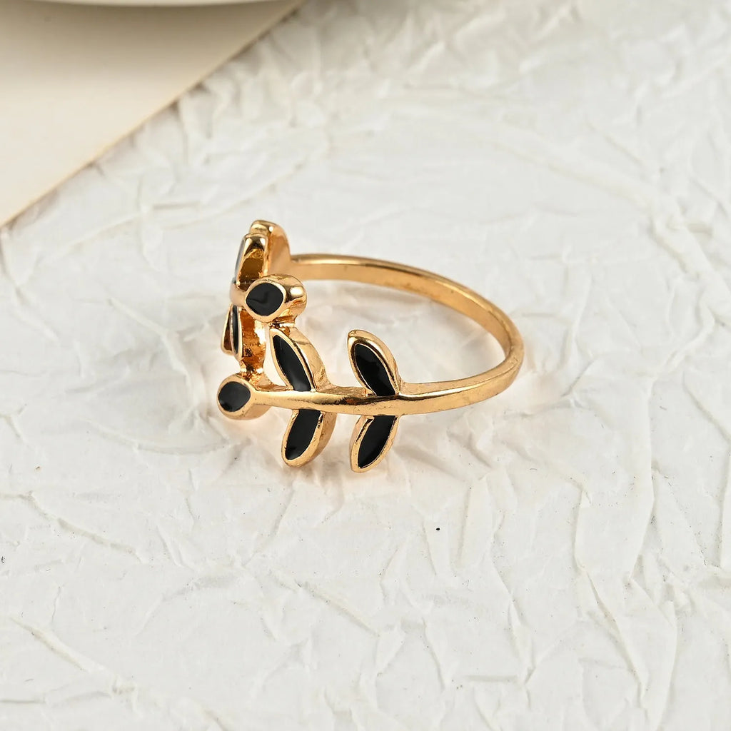 Geometric leaf ring with gold electroplated finish and simple floral design on finger