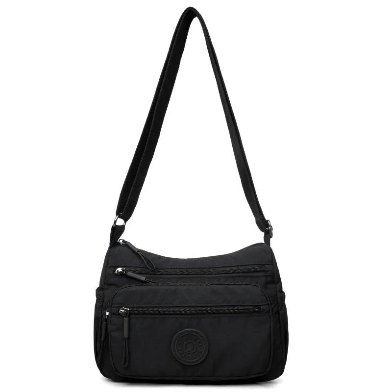 Soft water-repellent nylon crossbody bag showing three-dimensional pocket and adjustable shoulder strap