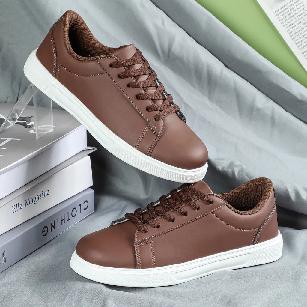 Beige brown platform skateboard sneakers with a cross-strap and round toe on a white background.