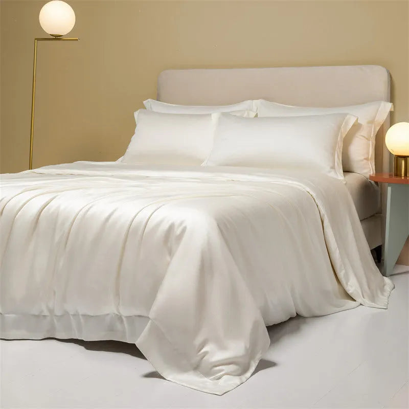 Aurora Blue 200 thread count Tencel duvet cover, fitted sheet, and pillowcases laid on a modern bed.