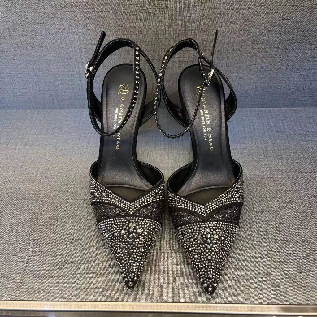 Women's silver hollow high heels with red sole and pointed stiletto heel.