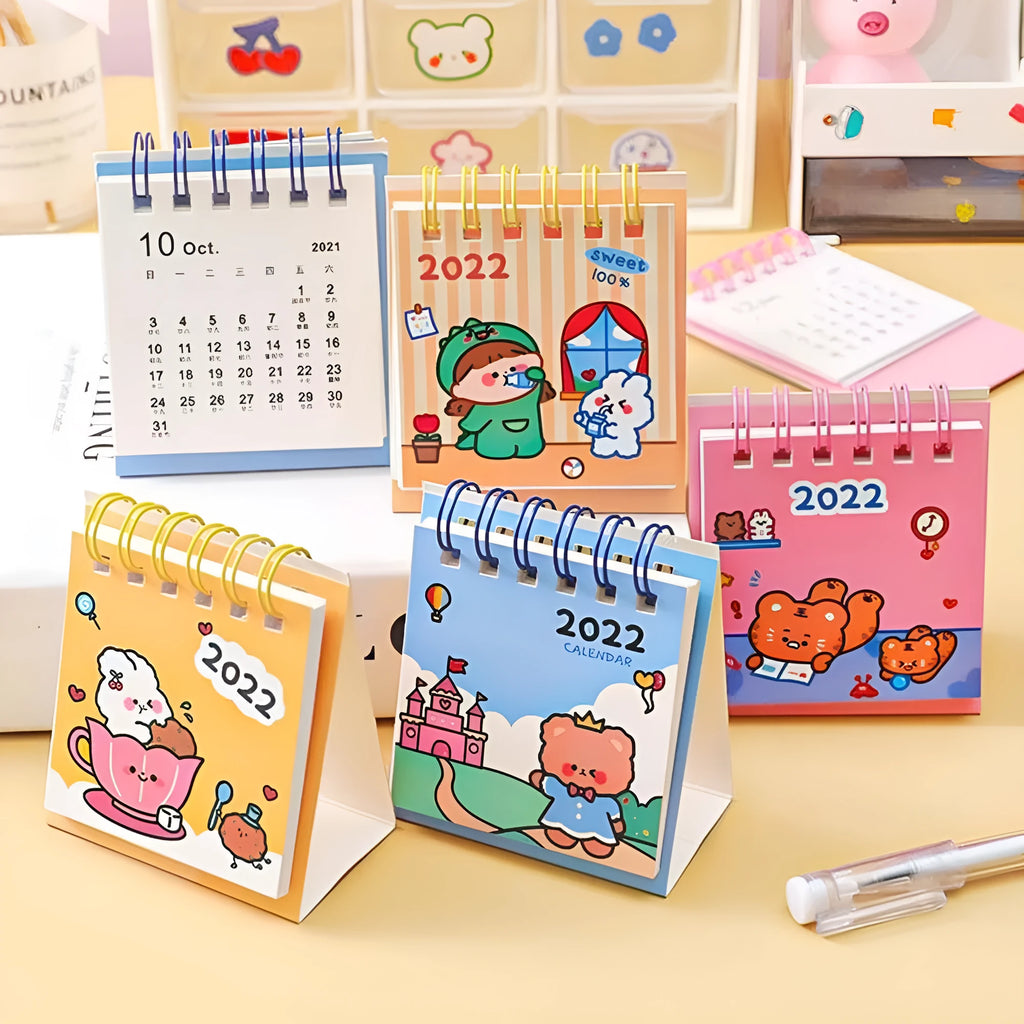 Mini desk calendar with cartoon design showing 9.3cm x 6.4cm paper calendar on a table