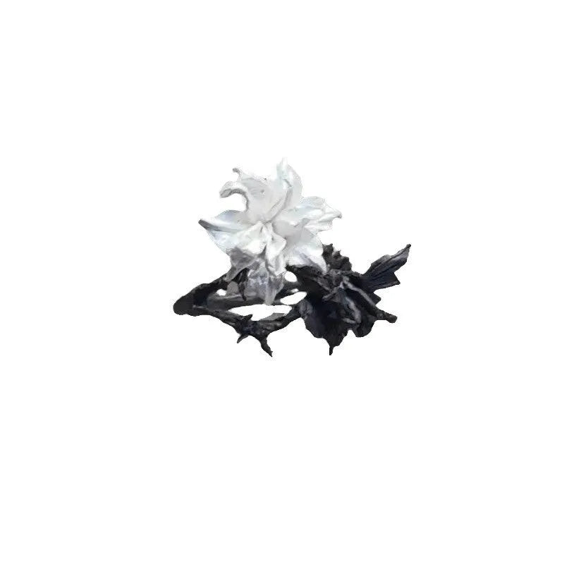 Open mouth copper ring with white and black colour separation and lily motif on a plain background