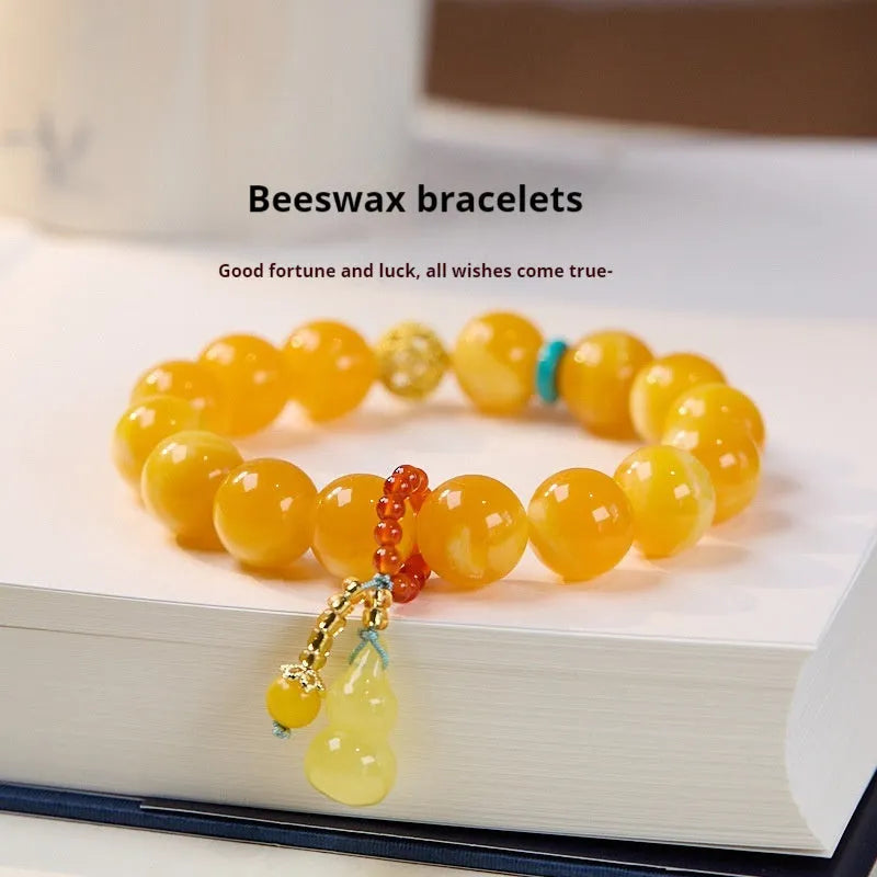 Natural beeswax Gourd Fu Lu bracelet in two sizes 12mm and 6mm on plain background