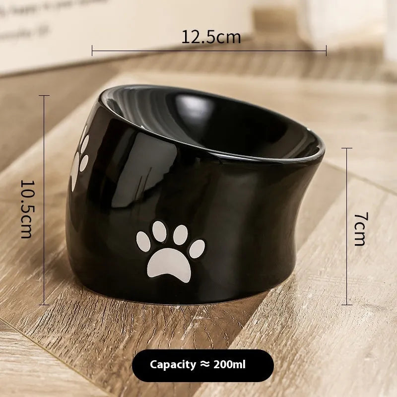 Ceramic cat bowl with cat paw design in black, showing oblique mouth style.