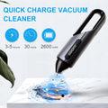 Black portable wireless handheld car vacuum cleaner with flat and brush attachments on a car seat