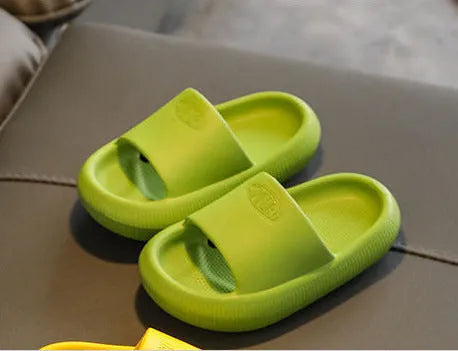 Children's mixed colour EVA slippers with textured non-slip soles and 1.5cm thick cushioning.