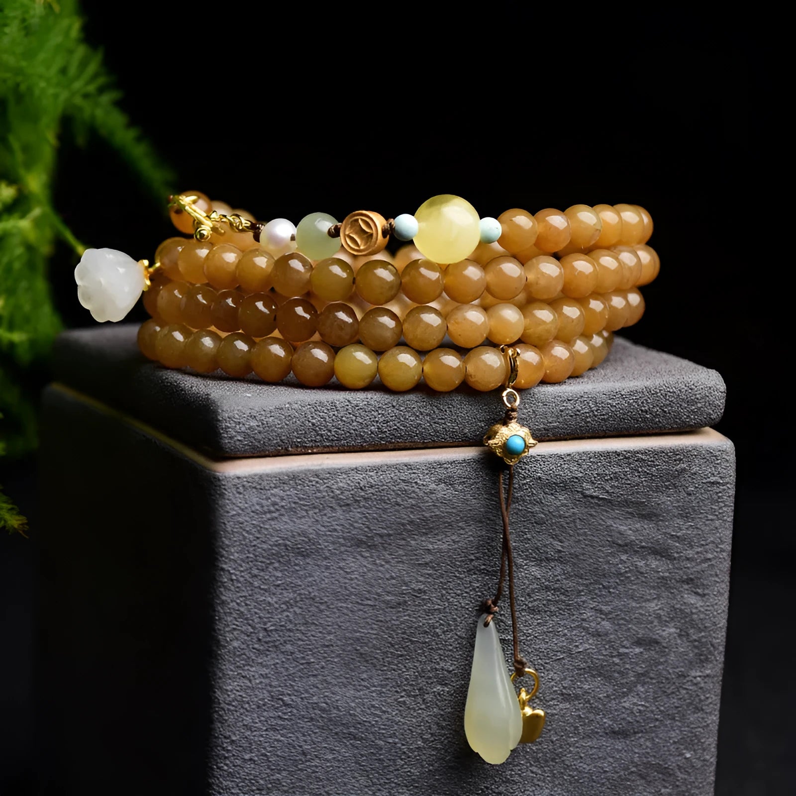 Women's green pine jade and beeswax bracelet with sequin leaves on a 6mm round bead strand.