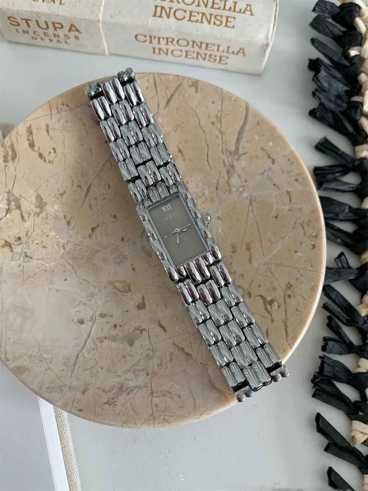 Women's silver and gold mid-ancient bracelet watch with 15mm dial and butterfly clasp.