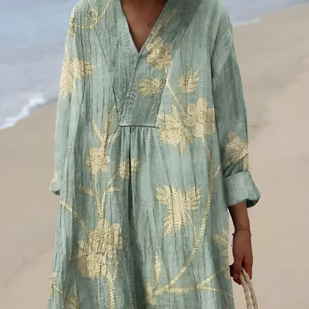 Long blue floral shirt dress with a 3D printed pattern, wide waist, and regular sleeves on a hanger.