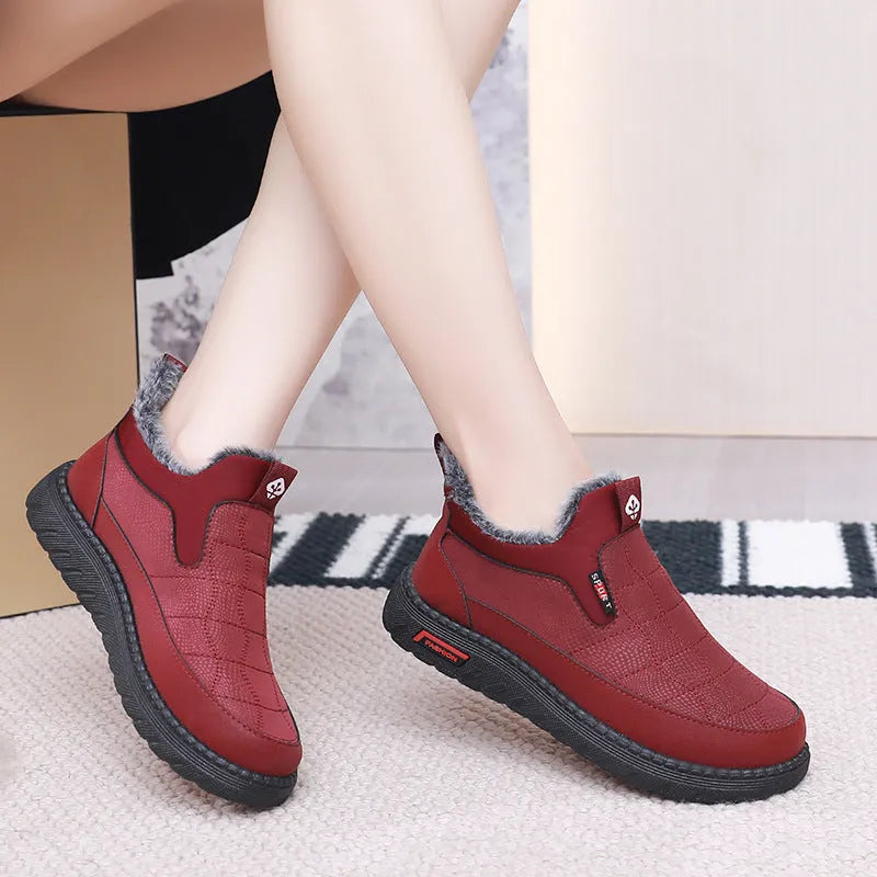 Women's black casual flat ankle boots with round toe and synthetic leather upper on a neutral background.