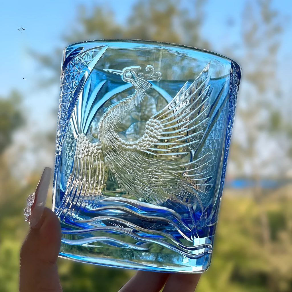 Hand carved crystal whiskey shot glass in sky blue with crane motif, 90x100mm