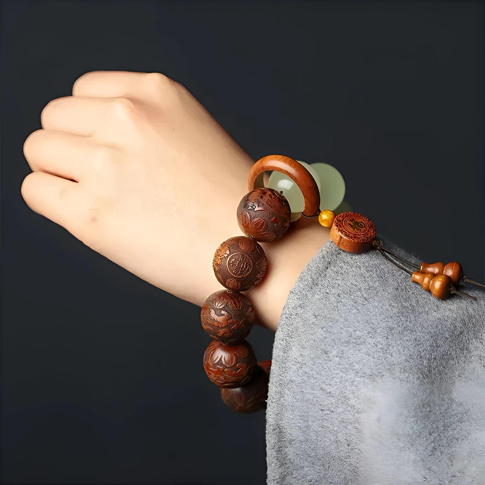 Rosewood flexible bracelet with fu character carving showing 20mm rings and amass fortunes colour finish