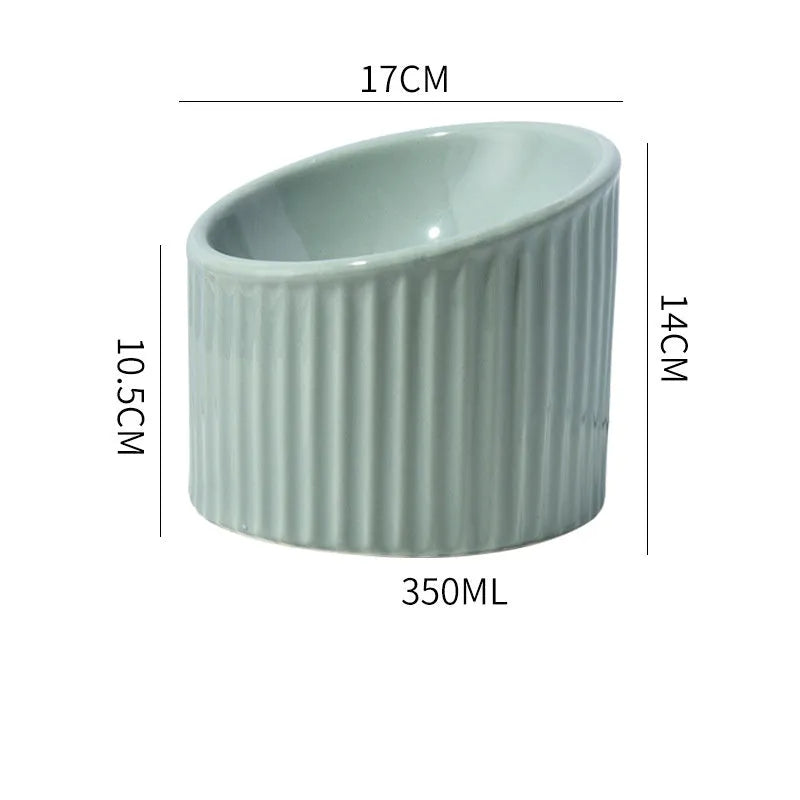 Ceramic elevated cat food bowl in green, showing tilted round dish on a raised stand.