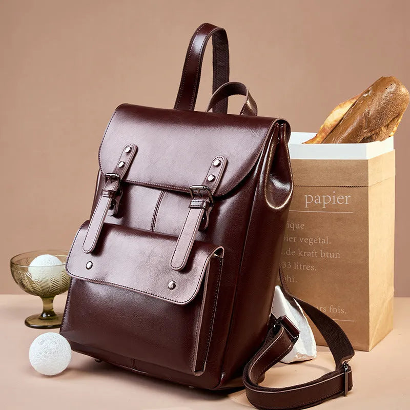Black genuine cowhide leather computer backpack for women with hard construction.
