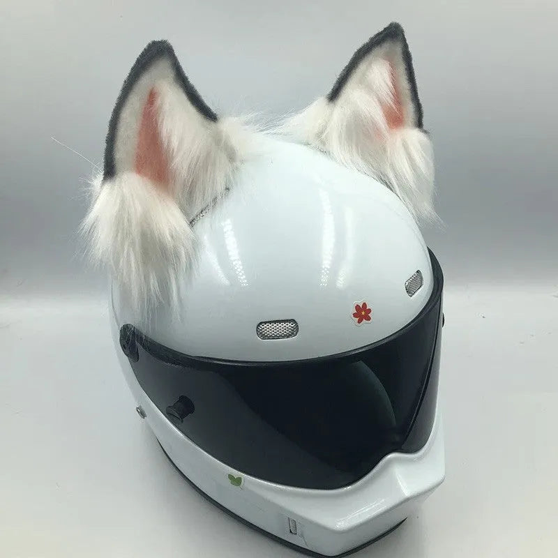 Set of black and white wolf ear and tail ornaments clipped to a motorcycle helmet