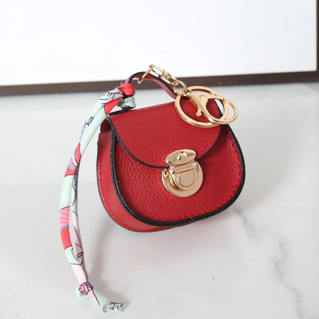 Small PVC coin purse with keychain in solid colour options including black, brown, orange, pink, red, and greige