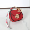 Small PVC coin purse with keychain in solid colour options including black, brown, orange, pink, red, and greige