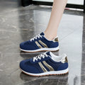 Blue women's lace-up tennis shoes with cross shoulder straps and a round toe