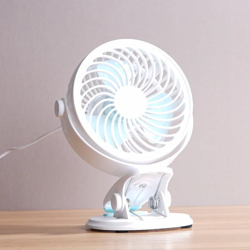 Small white USB desk fan shown in clip-on and floor-standing styles on a wooden desk