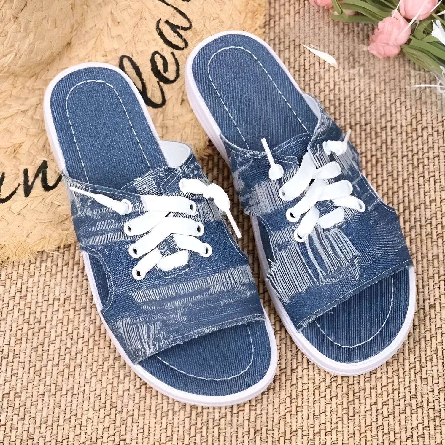 Blue Roman-style canvas slippers with cloth lining and rubber sole showing flat design